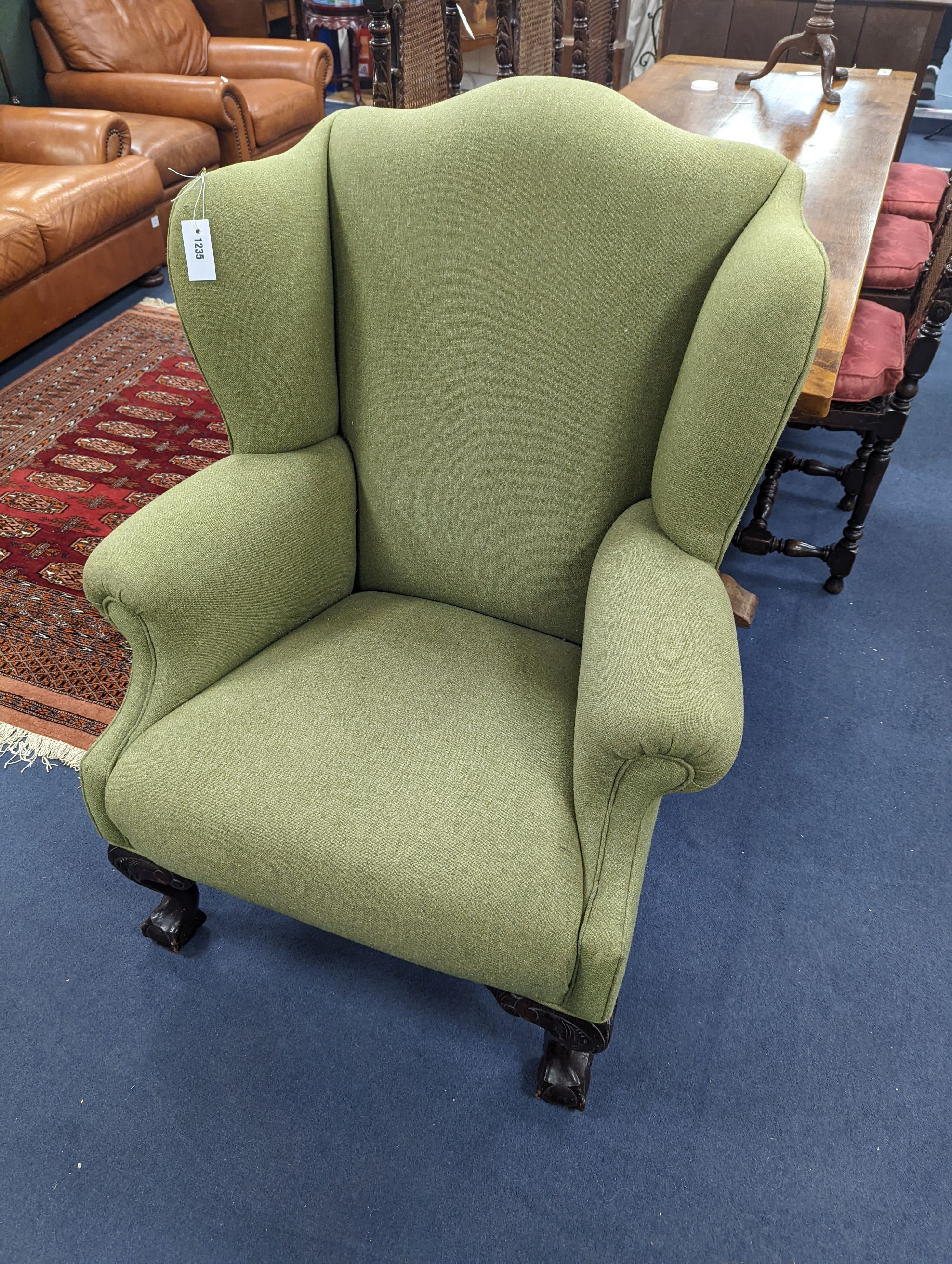 A George III style wing armchair upholstered in green wool fabric, width 86cm, depth 80cm, height 111cm